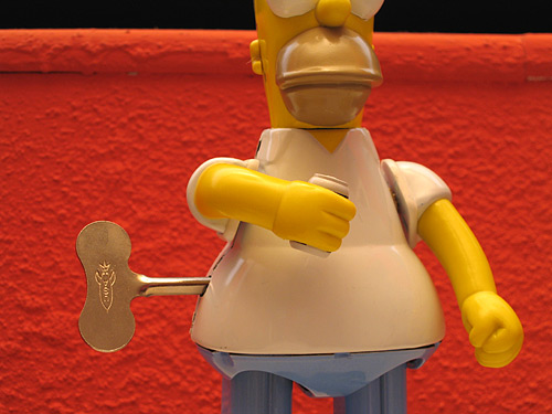 [tin Homer Simpson toy]