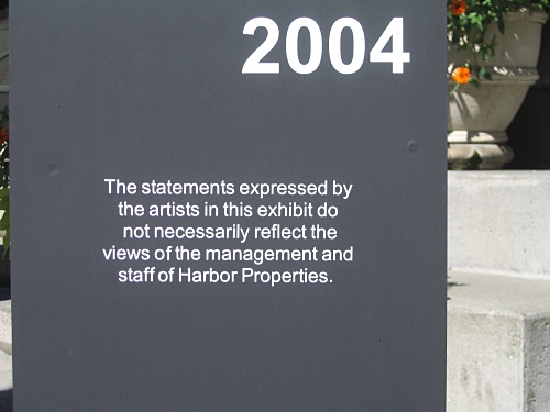 [sign:"The statements expressed by the artists in this exhibit do not necessarily reflect the views of the management and staff of Harbor Properties"]